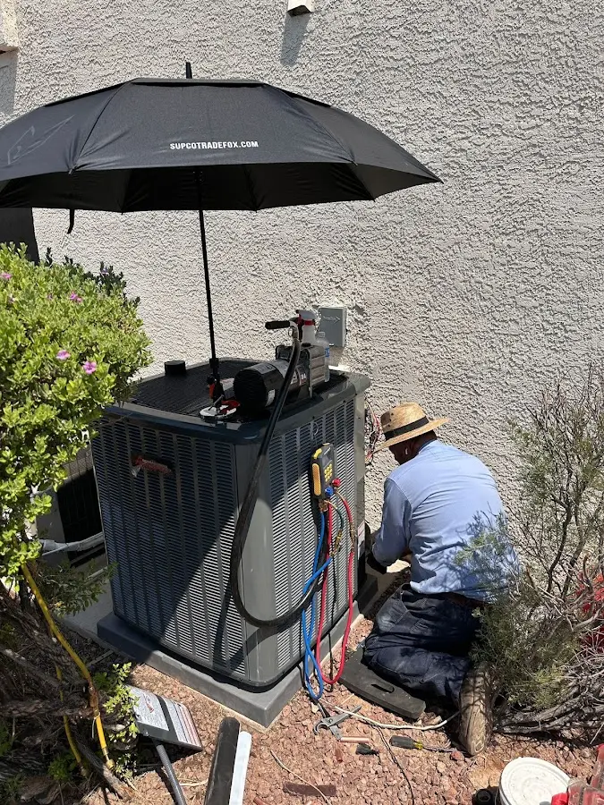HVAC technician performing outdoor AC maintenance in Crafton