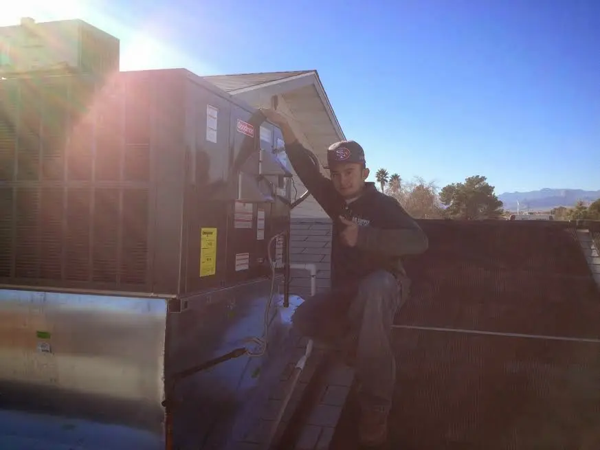 HVAC technician performing HVAC Inspection on a rooftop unit in Crafton